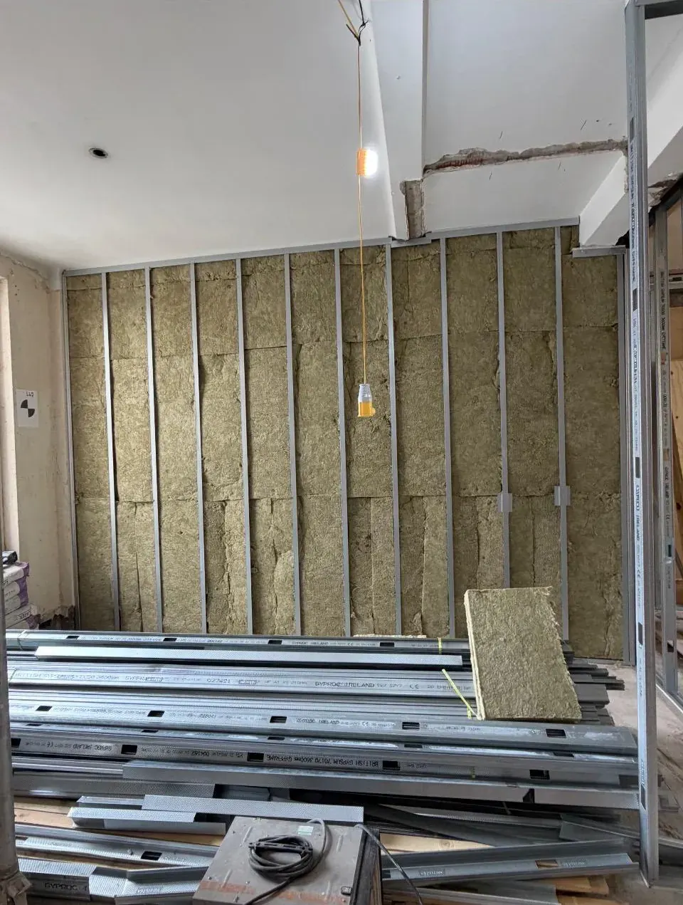 Acoustic mineral wool insulation fitted between metal studs