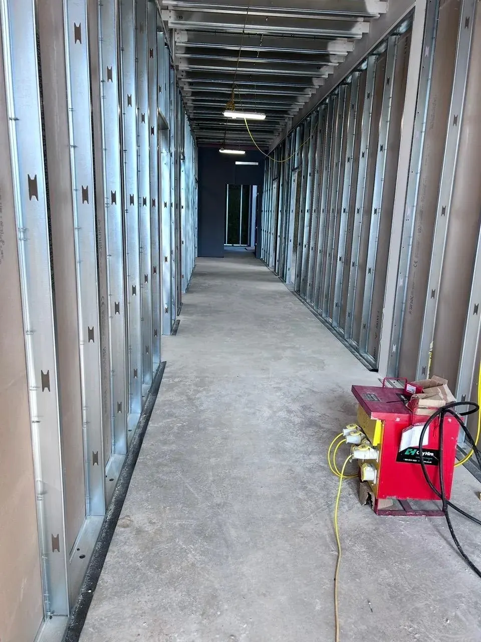 Long corridor of metal stud partition framing on a commercial fit-out