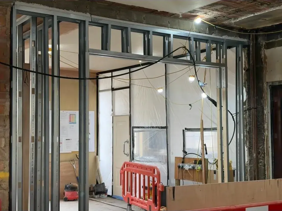 Stage 1: metal stud framing set out across an office floor