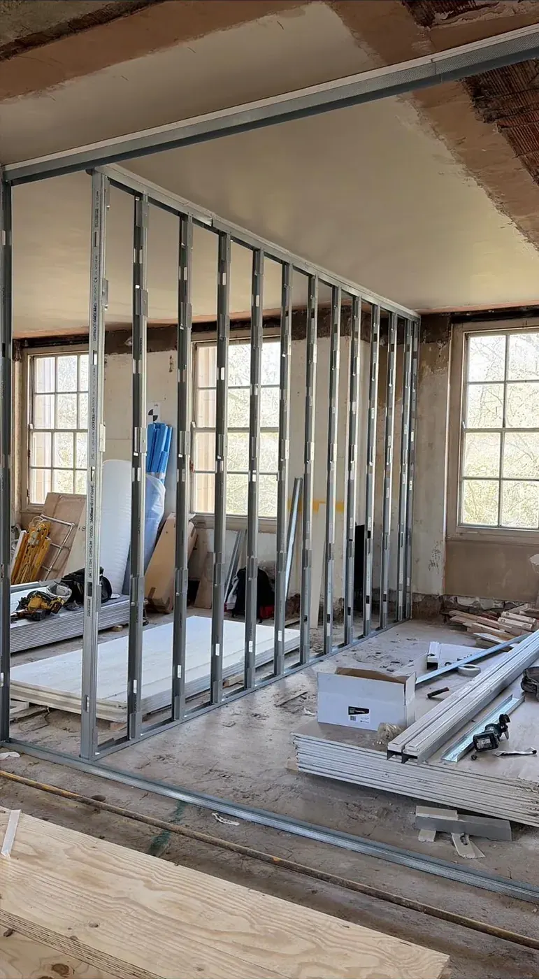 Metal stud partition wall under construction