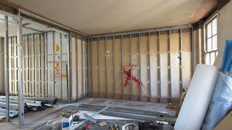 Room lined with plywood backing on metal studs